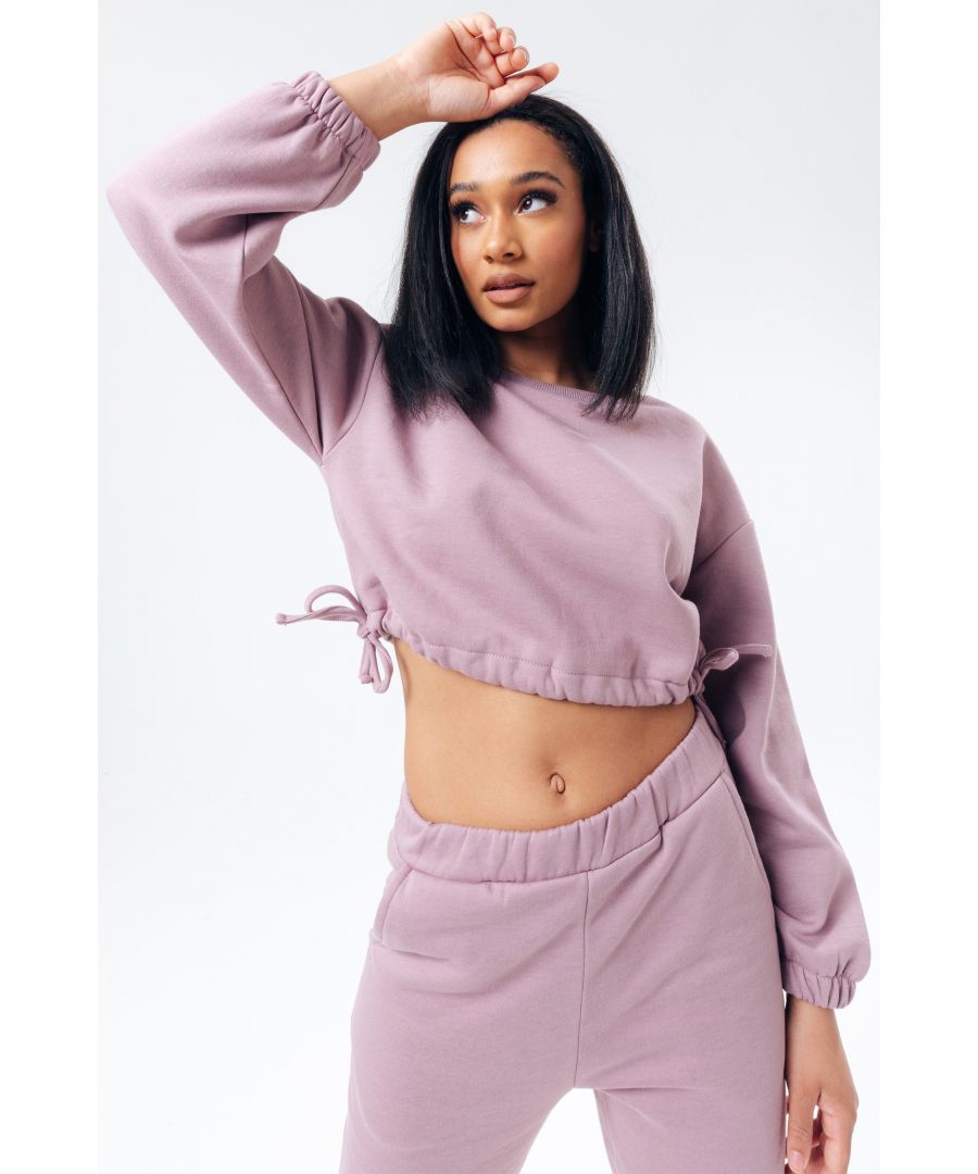 You can never have too many jumpers. The HYPE. blush women's cropped sweatshirt is your new go to. With a crew neck line, long sleeves, fitted stretch trims, tie sides and cuffs for a classic fit in our standard croppeed women's jumper. Designed in a 80% cotton and 20% polyester fabric base for supreme comfort. Wear with pink HYPE. women's joggers for a classic casual loungewear fit. Machine washable.