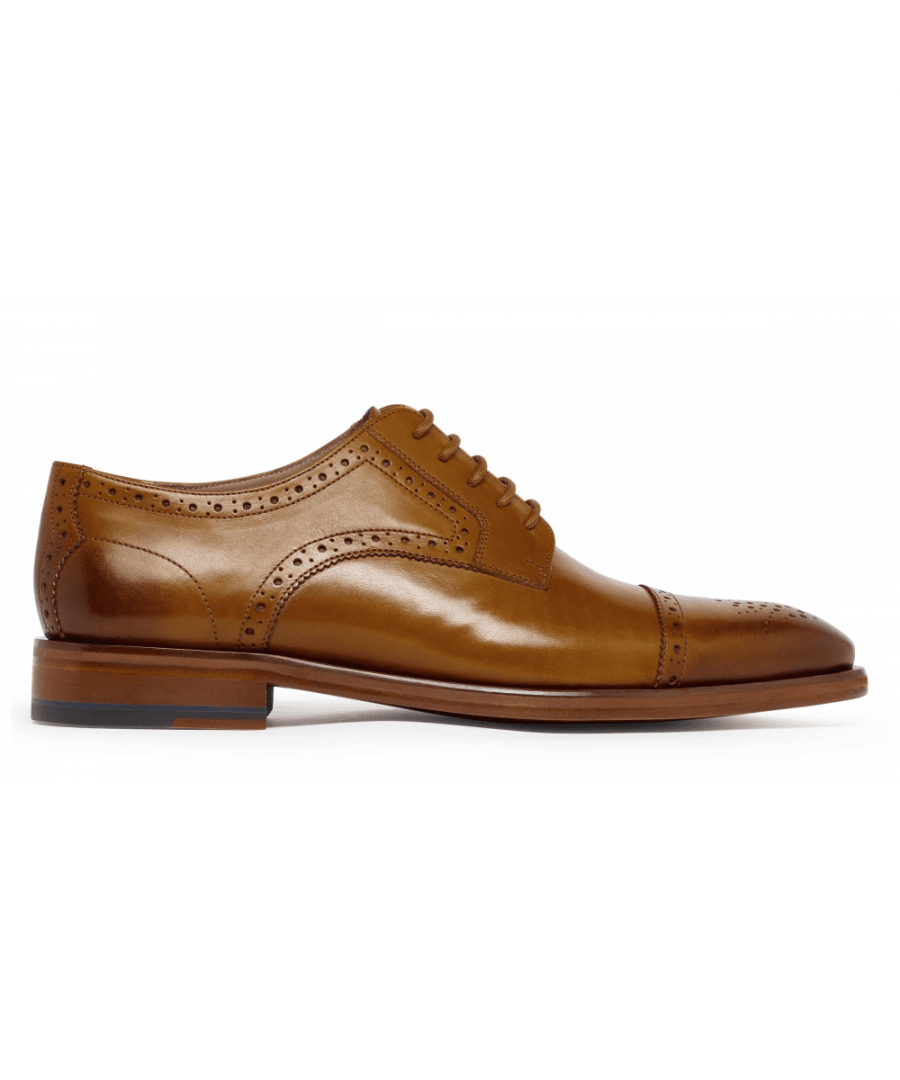 This Derby features brogue detail and a ‘medallion’ punch motif on a toe cap style. This is generally referred to as a Semi Brogue; a cleaner version of the traditional wingtip brogue.The upper is made from pristine Adigo calf leather in black, antique finished by hand, with a half leather lining and insock. Bridgeford is Blake stitched to a leather outsole with a rubber topped stack heel.\n\n\nBlake Stitched constructionAntiqued leather upperLeather liningLeather soleToe rosette\nMade in India\n\n\n \n 