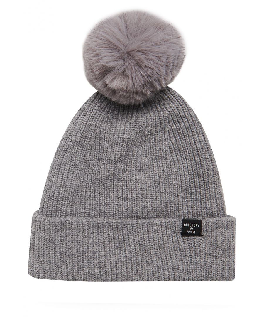 Keep the heat in this season with the Heritage Ribbed beanie, designed to keep you warm and looking your best!Fold up hemFluffy bobbleRibbed knit designSignature logo tab