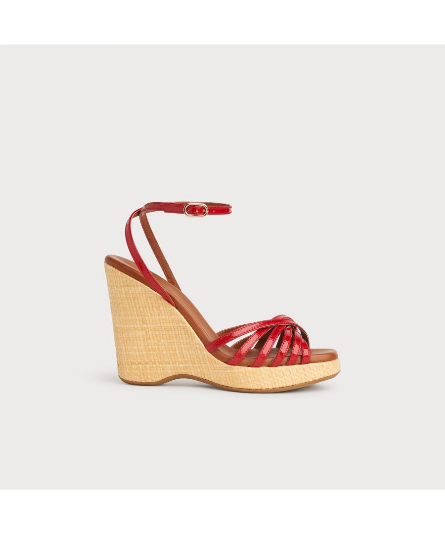 With a hint of Seventies' playfulness, our Solange wedges balance height and comfort. Crafted in Italy from red patent leather, they have a crossover multi-strap design, a delicate ankle strap and a beige raffia 110mm wedge sole. Perfect with summer's cool cotton and linen skirts and dresses, they're also great with wide leg trousers.