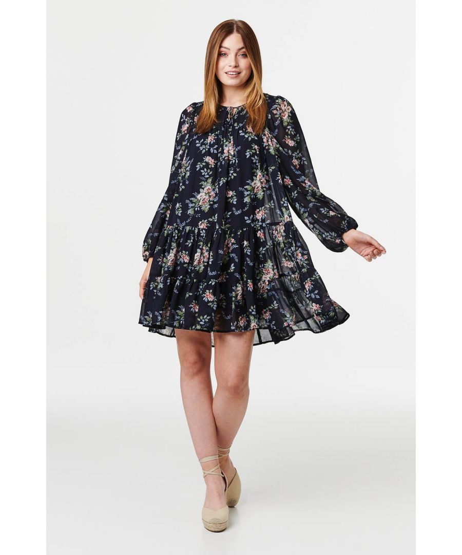 Make a statement on your next brunch date with this floral smock dress. With a round neck, long semi sheer sleeves and a short tiered smock skirt. Pair with heeled wedges for brunch or with knee high boots for the office.
