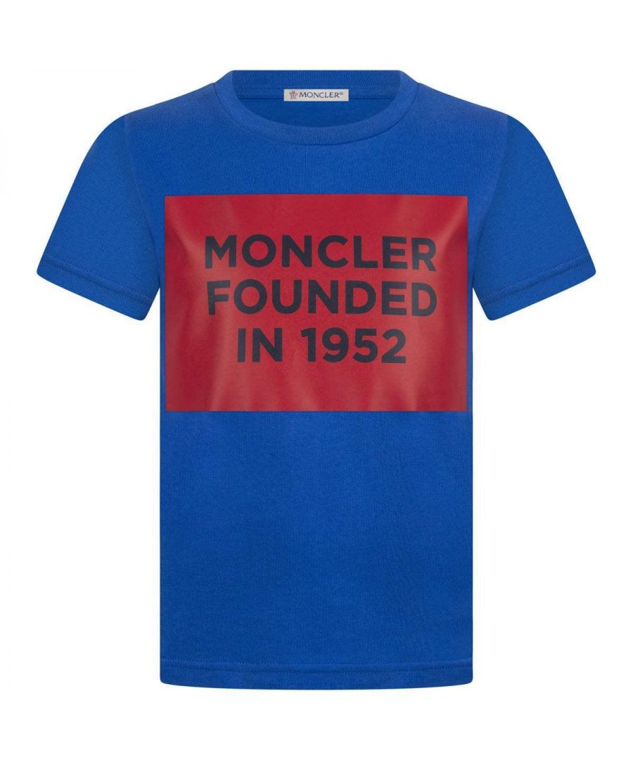 Boys blue t-shirt from Moncler. Features a rib-knit round collar, iconic badge applique on the shoulder and red box print on the front.