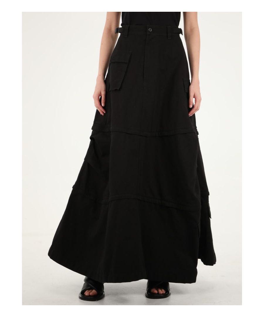 Black cotton cargo maxi skirt. It features zip and button closure, maxi flap pockets and belt loops. The model is 180cm tall and wears size FR 36.  