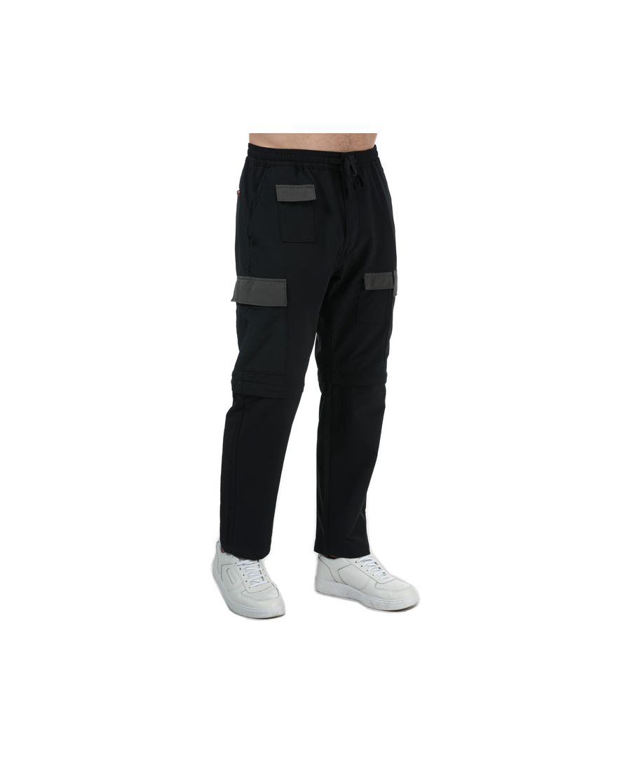Mens Levi’s Zip Off Cargo Pants in caviar.- Elasticated waist with drawcord.- Zip fly and button fastening. - Multi-pocket construction.- Zip-off detachable legs.- Warm  brushed ripstop fabric construction helps maintain body heat.- Sits below waist.- Loose fit through thigh.- Tapered leg.- 90% Polyester  10% Elastane.  Machine washable. - Ref: 39672-0006