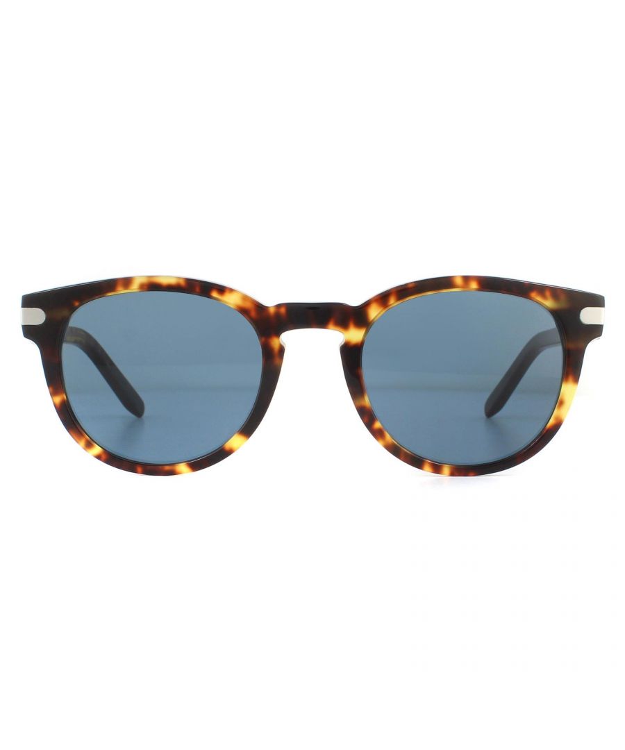 Salvatore Ferragamo Sunglasses SF935S 219 Dark Tortoise Blue have a chunky acetate frame with rounded lenses and a keyhole bridge. Temples feature a metal plaque engraved with the Ferragamo logo.