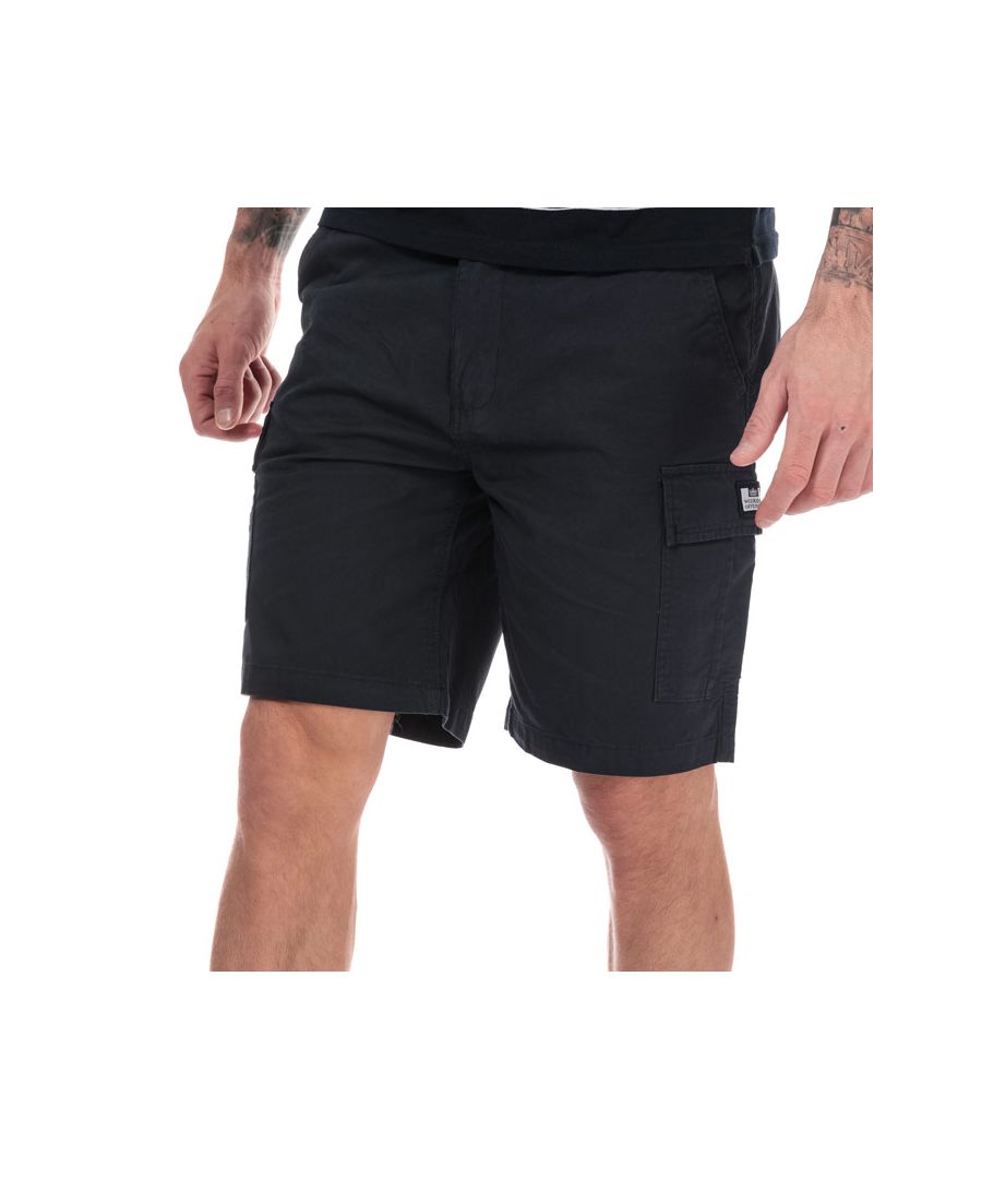 Mens Weekend Offender High Desert Cargo Short in Navy.- Zip fly.- Slip pockets to sides and reverse.- Button pockets to front.- Weekend Offender Printed Logo to side pocket.- Belt loops to waist.- Tonal stitching.- Main material: 100% Cotton. Machine washable.- Ref: WOSST501B