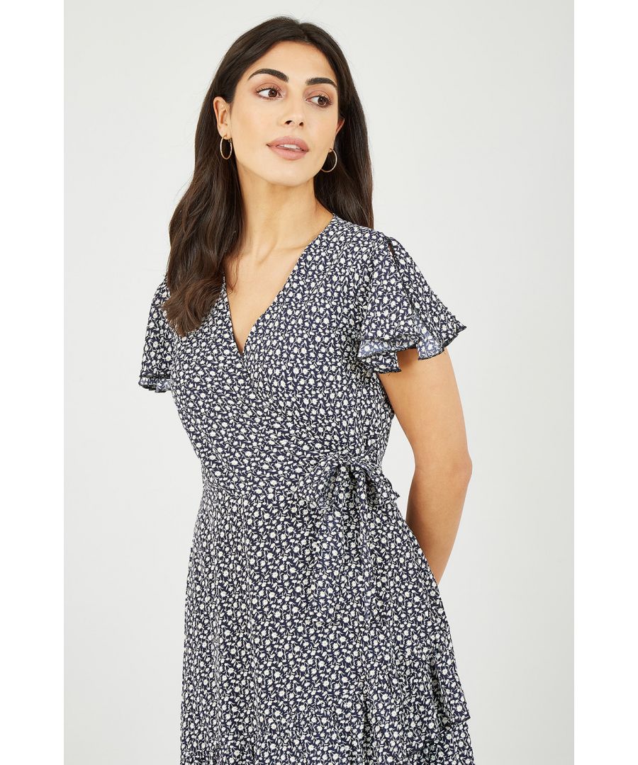 We love a versatile dress than can do it all, add trainers to keep in casual, or chunky heels to dress it up, The Mela Navy Ditsy Daisy Wrap Effect Frill Dress has you covered for anything! The flirty hemline has double ruffles to add movement, and the wrap effect neckline is topped with a frilly short sleeve. All wrapped up in that cute micro daisy print!