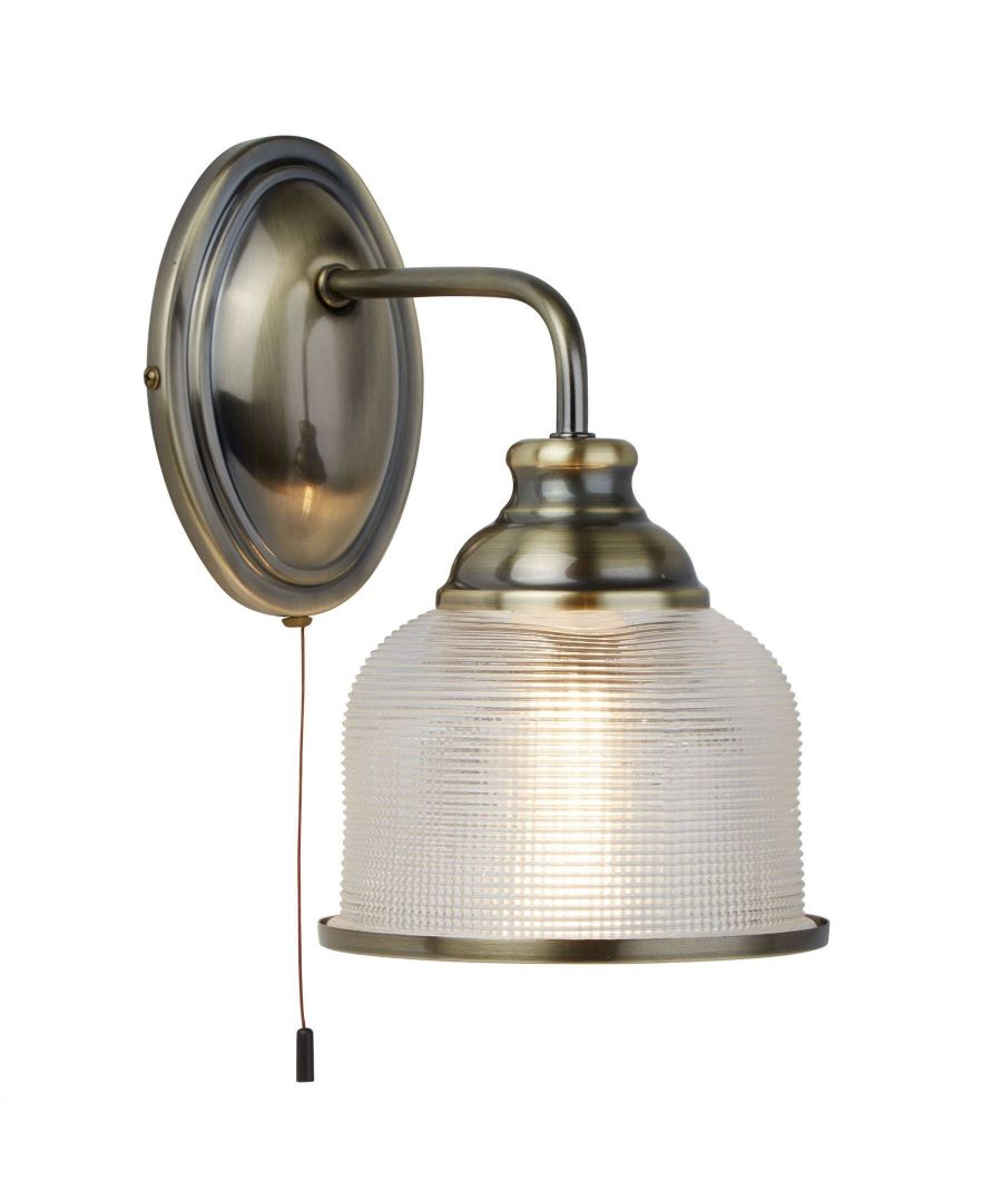 Make an impact using this attractive wall light, fit with a striking combination of antique brass and halothane glass. The beautiful ribbed effect shade is finished off with a complimentary antique brass trim. The fitting is complete with a pull-cord switch for your convenience. The range offers a choice of different sized fittings; allowing you to choose the best one for the size of your room. The fittings are also available in more than one finish. Class one. | Finish: Antique Brass | Material: Glass | IP Rating: IP20 | Height (cm): 25 | Width (cm): 15 | Projection (cm): 22 | No. of Lights: 1 | Lamp Type: E27 LED | Switched: Yes | Wattage (max): 7