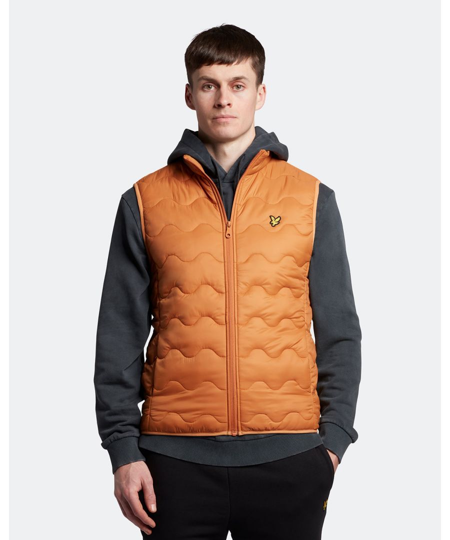 For a garment that can help you navigate the changing seasons with unique style, look no further than the Lyle & Scott Crest Quilted Gillet. Made with a lightweight nylon-polyester blend, his piece takes one of our most-loved silhouettes and adds a crested quilting that will turn heads right through to Spring. Finished with detail stitching, reinforced seams, front pockets and our signature Golden Eagle. \n \nFit: Regular\nIt is crafted to fit the body neither too tightly or too loosely, leaving you with a classic, timelessly stylish look. We recommend you order your usual size, but if you're caught between two, go a size up.