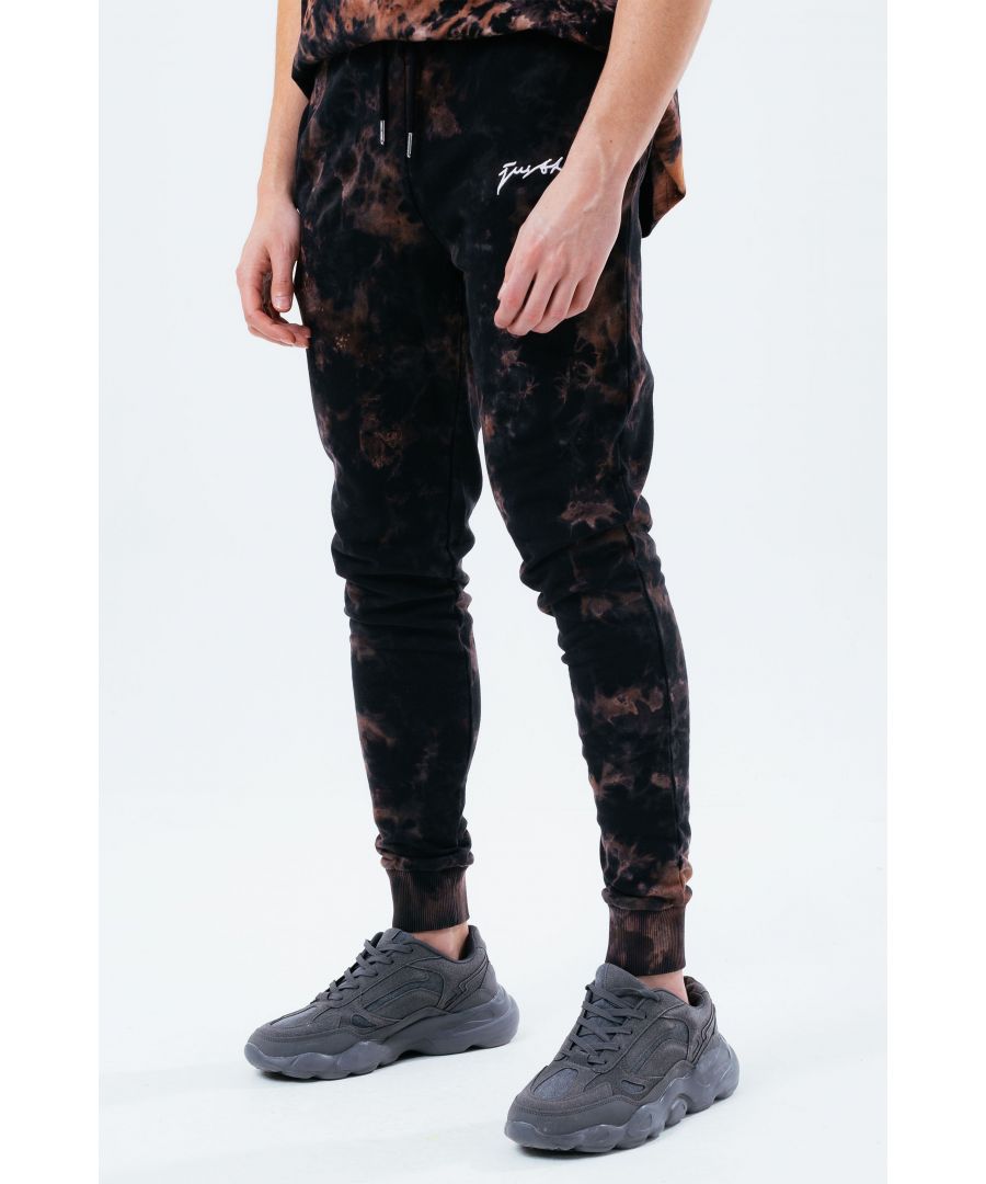 The HYPE. multi dark acid wash men's joggers feature a black and brown colour palette. Stay on trend and grab the matching hoodie to complete the set. Designed in a soft-touch 100% cotton fabric base with the supreme amount of comfort you need from your new joggers. The design boasts an acidic tie-dye wash finished with an elasticated waistband, drawstring pullers and fitted cuffs. Finished with the new! just hype scribble logo. Machine wash at 30 degrees.