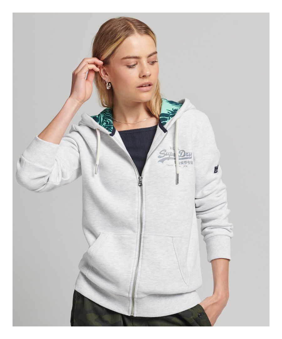 Our Inner All Over Print Zip Hoodie is a unique way to layer up. Our traditional zip hoodie is a trusted design that is sure to bring you comfort and warmth, thanks to its brushed lining and ribbed trims. We've taken this design one step further by including a print hood lining so you can feel confident while you make a subtle statement.Relaxed fit – the classic Superdry fit. Not too slim, not too loose, just right. Go for your normal sizeDrawcord hood with print liningZip fasteningPrint logoTwo pocketsRibbed cuffs and hemBrushed liningSuperdry tab
