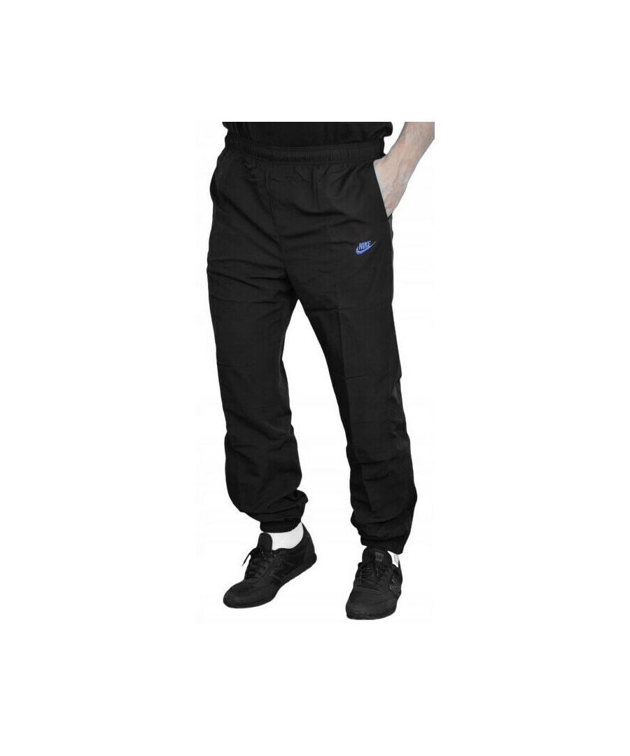 Nike Mens Light Weight Woven Track Pants.  \nElastic Waistband With Inner Drawstring Closure.  \n2 Hand Pockets,  Additional Secured Zip Pocket on the Left Leg.   \nElastic Waistband at the Ankles With Zip Closure Details Going Down Both Sides.   \nPerforated Stripes and a Breathable Mesh Lining for Comfort.  \nOther Details Include a Contrast Nike Swoosh and Logo Embroidery on Left Thigh.  \nLarge Contrast Nike Wordmark on Back of Lower Right Leg.  \nLogo and Nike Tab Red Stitching on Back of Upper Right Leg.\nIdeal for Training and Daily Activities.