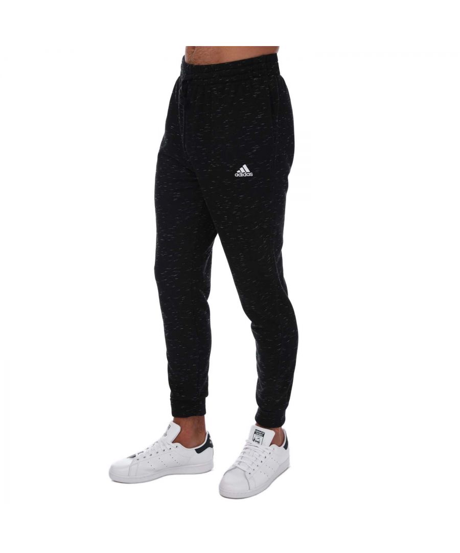 Mens adidas Essentials French Terry Melange Pants in black.- Drawcord on elastic waist.- Front pockets.- adidas Badge of Sport on the hip.- Cuffed hems.- Regular fit with a mid rise and a tapered leg.- Main material: 53% Cotton  36% Polyester (Recycled)  11% Rayon.- Ref: HE1794