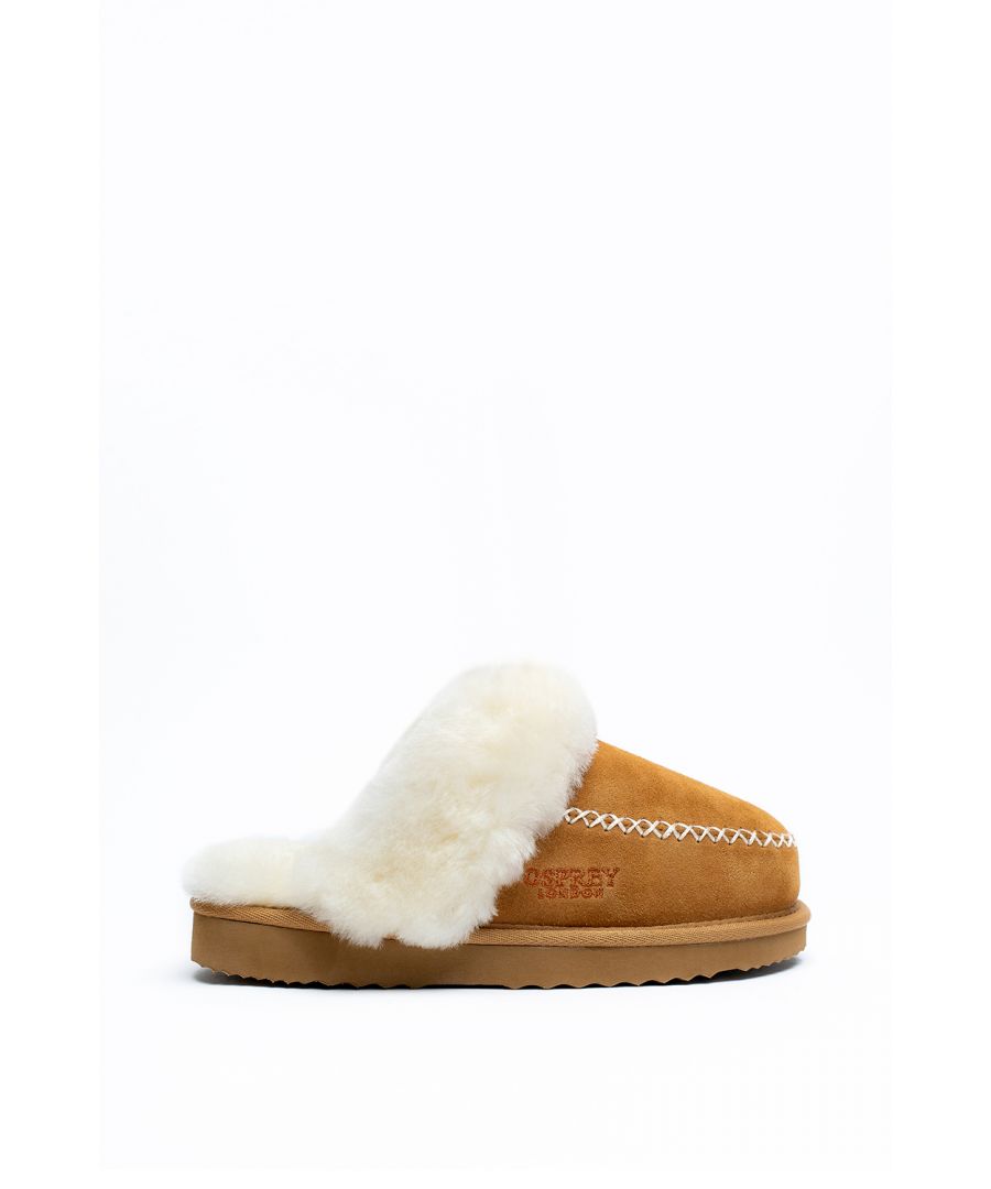 Reasons to love them: Made from sumptuous cow suede and sheepskin | Modern contrast cross stitching and fluffy lining | Slightly textured gums sole for added grip to carpet | With luxurious cow suede upper and sumptuous fluffy sheepskin lining, The Cleste mule slipper has many gorgeous features. It's padded comfort insock is lined with hair on sheepskin that creates a fluffy warm footbed and collar, perfect for chilly winters. It's EVA gum sole is slightly textured to allow better grip when wearing on carpet, allowing you to stay cosy, no matter where you are in the house. Contrast cross stitching adds a sophisticated pop of colour, while matching the fluffy collar perfectly. The Celeste also features classic Osprey London branding that beautifully contrasts the upper while also matching the stitch and collar, making this slipper stylish and sleek. Order yours now to avoid disappointment.
