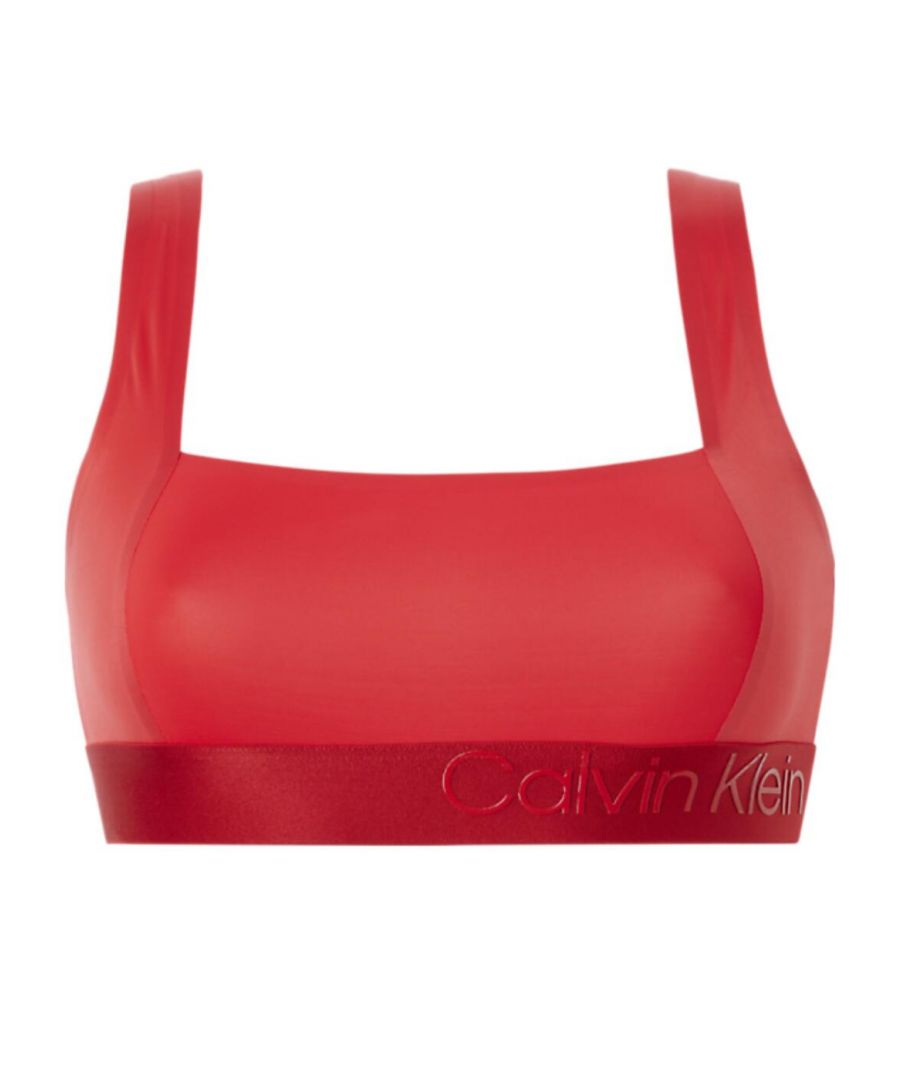 The Gloss unlined bralette by Calvin Klein boasts a sleek low-cut neckline that is easily concealed under clothes. This bralette is unlined and wireless giving you a natural feel and all-day comfort. The light high elastane count will help to give you light support. Wider straps give you a more comfortable fit and help ease the strain on your shoulders. Subtle Calvin Klein branding is seen on the side of the elasticated band. The embossed effect gives a unique look and feel to the branding.\n\nWide straps give a more comfortable fit\nSubtly embossed branding\nWireless\nPull-on design\nNon-padded\nCountry of origin: Sri Lanka\nComposition: 67% Nylon | 33% Elastane\n\nListed in UK sizes