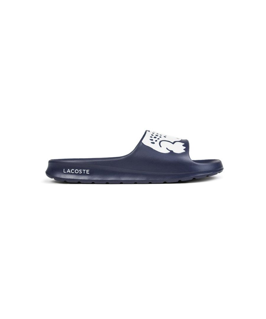 Step into on trend summer style with these mensCroco Slides from Lacoste. In a bang on trend colourway, these designer sandals are delivered in a smooth synthetic upper with Croc detailing across the forefoot foot strap. The one piece upper delivers a super comfy footbed which moulds to your feet delivering the perfect fit and feel while the grippy outsole will keep you sure and safe around the pool or in the shower. These designer slides are finished with eye catching Lacoste branding throughout just in case you want a sign of approval that youre wearing cool on trend style this summer season \n - One piece synthetic upper\n - Comfort moulded footbed\n - Grippy outsole\n - Slip on wear\n - Iconic Lacoste branding throughout\n Please Note: These slides are supplied poly bagged (without box)\n These Lacoste Slides are sold as B grades which means there may be some very slight cosmetic issues on the shoe and they come in a poly bag. There could be occasional issues with wrong swing tags being allocated to wrong shoes by Lacoste themselves which could result in some size confusion but you must take the size IN THE SHOE as the size that the shoe actually is ( not what is on the tag ). We have checked most of the shoes and in our opinion,all are practically perfect without any blemishes on them at all and in essence if the shoes did not have the letter B denoted on the swing tag you would presume these were perfect shoes. All shoes are guaranteed against fair wear and tear and offer a substantial saving against the normal high street price. The overall function or performance of the shoe will not be affected by any minor cosmetic issues. B Grades are original authentic products released by the brand manufacturer with their approval at greatly reduced prices. If you are unhappy with your purchase, we will be more than happy to take the shoes back from you and issue a full refund