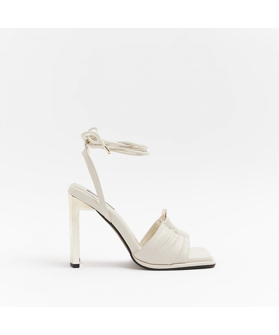 > Brand: River Island> Department: Women> Colour: Cream> Type: Sandal> Style: Strappy> Material Composition: Upper: PU, Sole: Plastic> Material: PU> Upper Material: PU> Pattern: No Pattern> Occasion: Casual> Season: AW22> Closure: Buckle> Shoe Width: Standard> Heel Style: Stiletto