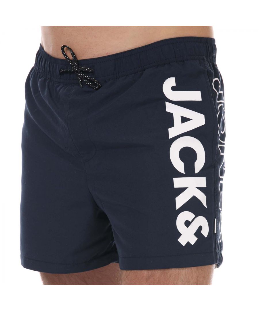 Mens Jack Jones Aruba Swim Shorts in navy.-Elasticated drawcord waist.- Two slip pockets.- Mesh inner brief.- Printed branding.- Quick drying fabric.- Shell: 100% Polyester. Lining: 100% Polyester.- Ref: 12187005A