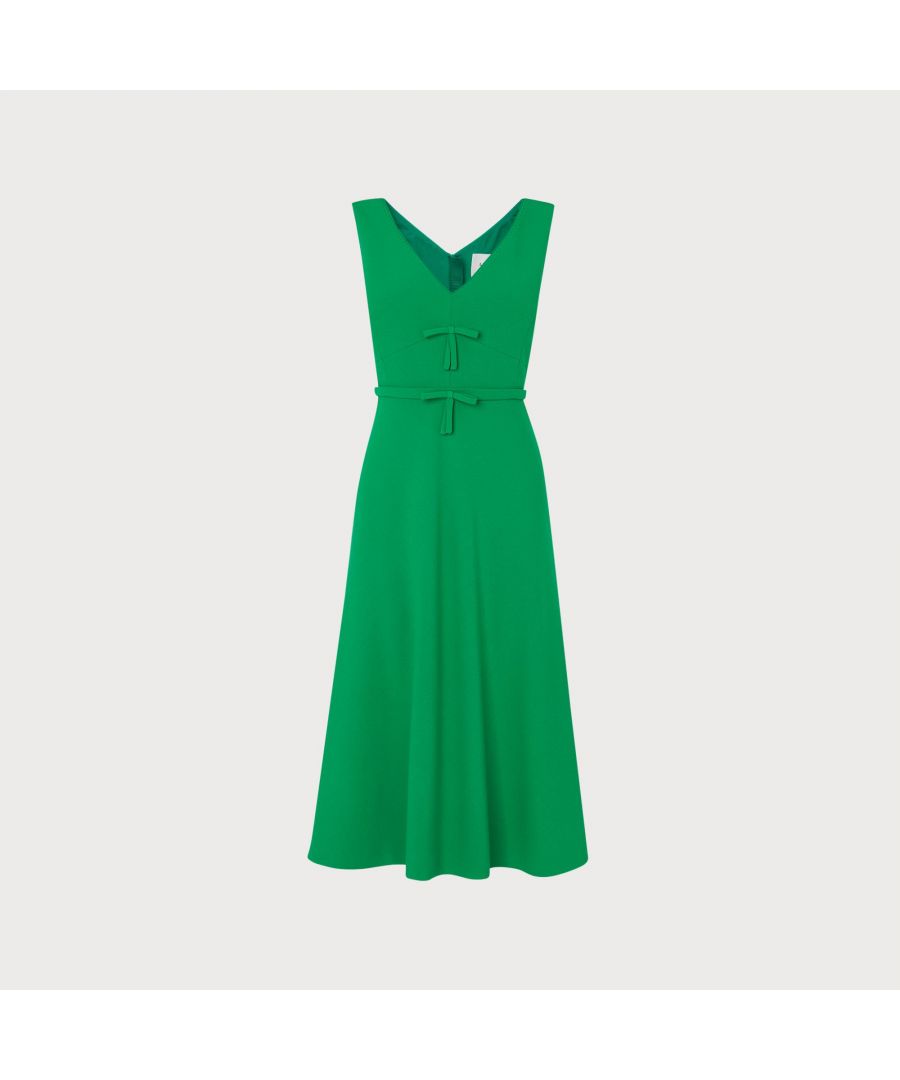 Understated and elegant, our Willow dress takes its design cues from vintage haute couture. Crafted from emerald green crepe, this sophisticated, sleeveless style has a V-front and back, two bows to the bodice, a nipped waist and a midi skirt with a flippy hem. Wear it with a colourful pair of satin courts and clutch for any summer occasion.