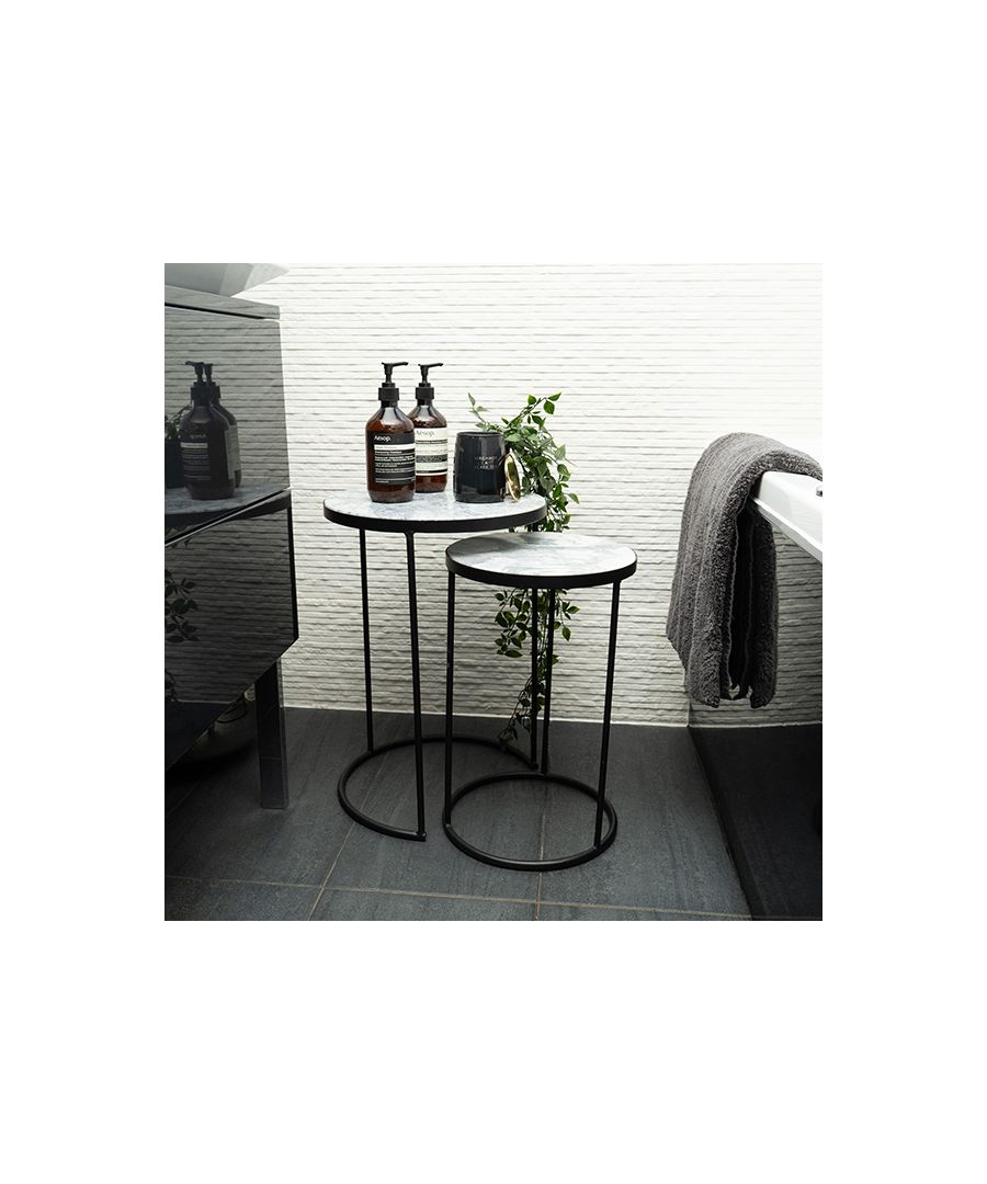 These round nesting side tables combine glamour and upscale elegance with refined minimalism, offering a space-saving solution with a lavish and contemporary design. Designed with high contrast colours for maximum aesthetic intrigue, the black marble side tables forge black metal together with a white marble effect top.\nSure to invoke an aura of opulence to your interior design, the set of two nesting tables would fit fabulously in any room of the house. Whether you use them as console tables or end tables, bedside tables or coffee tables, the set will bring opulence abound to your home. Eye-catching lines meet decadent materials in these nesting tables. The geometric design of the nesting side table pair not only makes storage simple, but also evokes the striking design style that typified the Art Deco era.\nFunctionality and effortless style coalesce to form the perfect pair, manifested in this set of round marble side tables. Invite the Art Deco opulence of the black and marble design into your space for tireless contemporary style.\nFeatures:\n\nNesting tables\nMarble-effect top\nComes as a pair\n\nProduct Specifications:\n\nProduct Type: Table\nWeight: 8.2kgs\nDimensions: H50.8cm x W35.3cm x D35.3cm & H45cm x 28.5cm x 28.5 cm