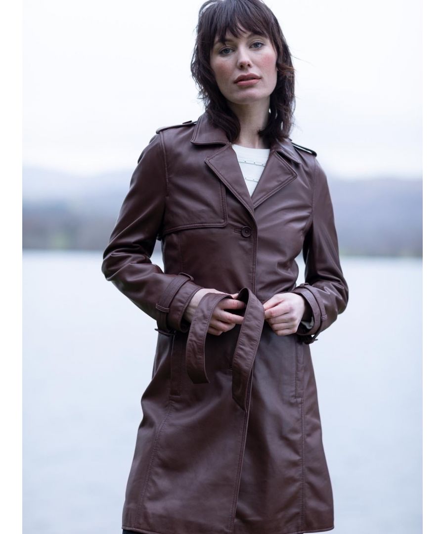 Our re-imagined ladies' leather trench coat; the Tarraby. This is a classic leather trench coat, crafted without compromise, and quite frankly, without competition. The luscious deep pecan brown offers an antique appearance, and the UK sourced aniline leather is not only butter-soft to the touch, but will enhance the vintage aesthetic as it develops over time. The Tarraby is complete with traditional trench details, inspired by its military heritage; 3 front buttons, belted waistline, lapel collar, gun flaps, storm pockets, epaulettes and collar buckles. Falling to the knee in length, this leather trench coat is a versatile wardrobe essential, crafted to last a lifetime.