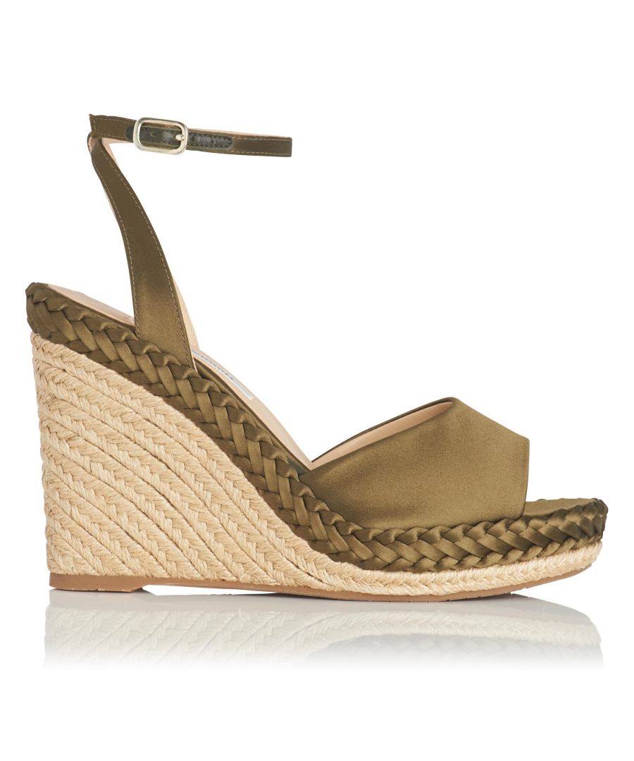 Give your outfit a little lift this summer with the stylish heights of our Daisie wedges. Designed from stunning khaki satin, these sunshine-ready peep-toe sandals are set on a summery raffia wedge, beautifully complemented by an elegant plaited detail and a sleek ankle strap.