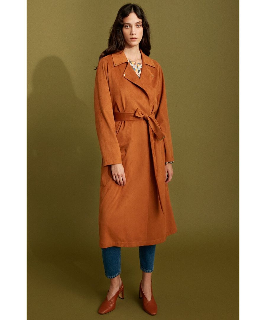 Through its flowy fabric and soft texture, this take on the classic trench coat is perfect for seasonal transitions. This terracotta, trench style coat is defined by a clean-cut silhouette, narrow shoulders, and a wrap close belt. The refined silhouette can be worn belted for a fitted look combined with your favourite dress and heels or simply with sneakers and jeans for a more casual daytime look.\n\nMid-calf length\nLong sleeves\nWrap close belt\nTerracotta colour\nModel is 5'10