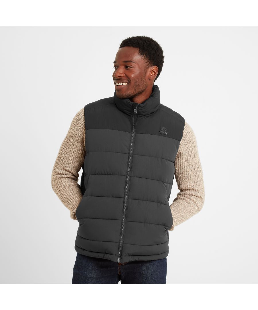 Designed by our team in West Yorkshire to keep the wind out and the heat locked in, our Murton men's gilet keeps your body warm and your arms free for a full range of movement. This extra warm puffer is quilted with chunky, stitched baffles and thickly padded with a warm, insulated eco filling, so you'll be helping the planet too. Murton comes in colours inspired by the rugged Yorkshire landscape and has a contrast colour neck and yoke, that matches the cuffs, to lift it out of the ordinary. There are two lower, angled zip up pockets perfect for storing your valuables or keeping your hands warm if you forget your gloves. The finishing touch is our signature rubber TOG24 rose badge proudly displayed on the chest.