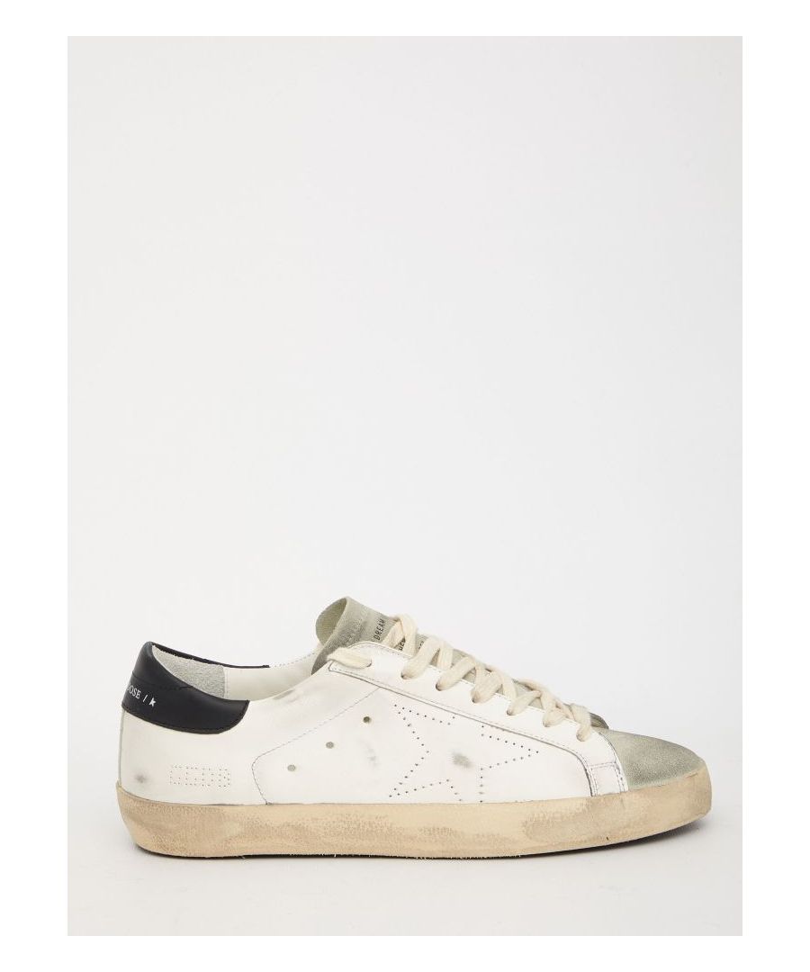 Super-Star sneakers in white leather with black heel, suede toe and a metallic insert. They feature lace-up closure, perforated side star, Golden Goose logo on heel and vintage effect.ITA size.