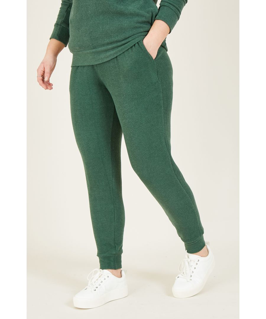 Uplift your loungewear with our Yumi Velour Loungewear Joggers. In an easy shape, it's designed with a tapered leg to ensure a flattering fit. On the waist, this pair of loungewear trousers feature a drawstring tie crafted from luxurious velour for a modern feel. The soft and stretchy fabric creates a comfortable fit, complemented by cinched cuffs for the perfect finish. Pair with an oversized jumper, slippers or pop on a pair of trainers with a shirt for everyday style. Or, choose the matching hoodie from our range.  70% Viscose 25% Polyester 5% Elastane Machine Wash At 30