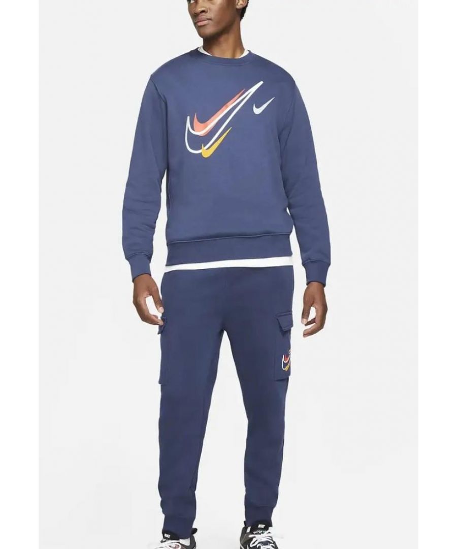 Nike Sportswear Fleece Full Tracksuit.       \nCrew Neck Top, Sportswear Multi Swoosh Graphic.      \nRibbed Neckline, hem and Cuffs.      \nElasticated Waist Concealed draw cord Cuffed Joggers.      \n2 Side Pockets, 2 Cargo Flat Pockets Secured with Pressed Buttons.      \nSoft and Comfortable Feel Fabric.