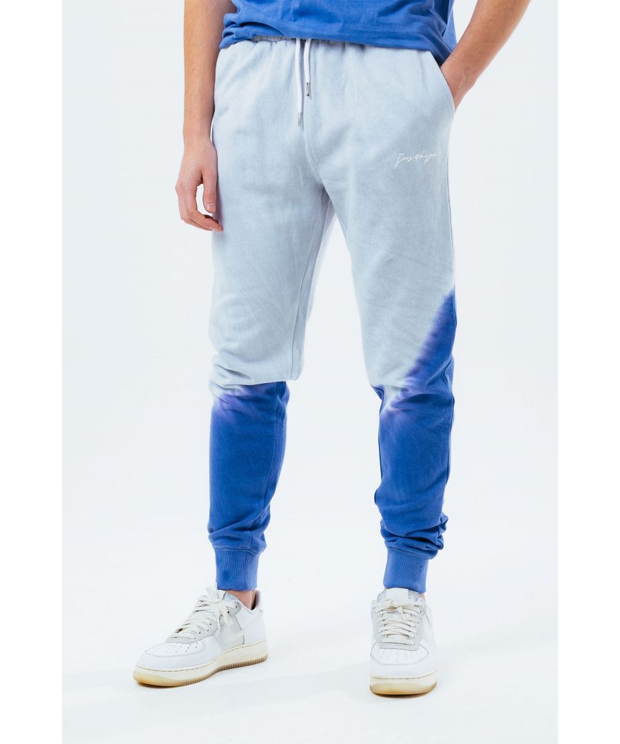 Stay on trend with the Hype Grey Navy Tie Dye Scribble Logo Men's Joggers and grab the matching hoodie to complete the set. Designed in a soft-touch 70% Cotton 30% Polyester fabric base with the supreme amount of comfort you need from your new joggers. The design boasts an acid wash or tie-dye wash finish with an elasticated waistband, drawstring pullers and fitted cuffs. Machine wash at 30 degrees.