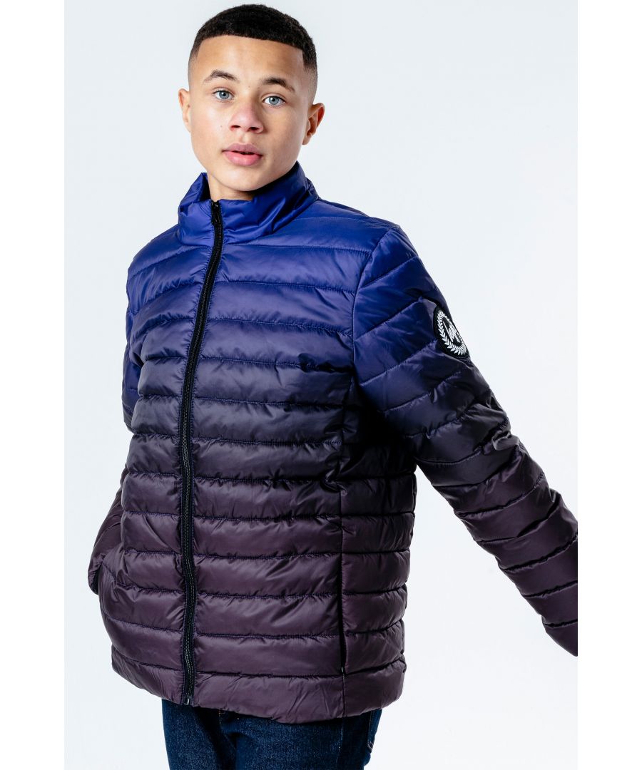 Meet the HYPE. Black Blue Fade Kids Lightweight Puffer Jacket, here to keep you warm in the colder months. Designed in our unisex puffer shape in a quilted comfy fabric with the iconic HYPE. crest embroidered onto the sleeve. A versatile jacket perfect for girls, boys and gender-neutral. Finished with fitted cuffs and double pockets in our signature gradient fade effect in a black and blue colour palette. Machine wash at 30 degrees.