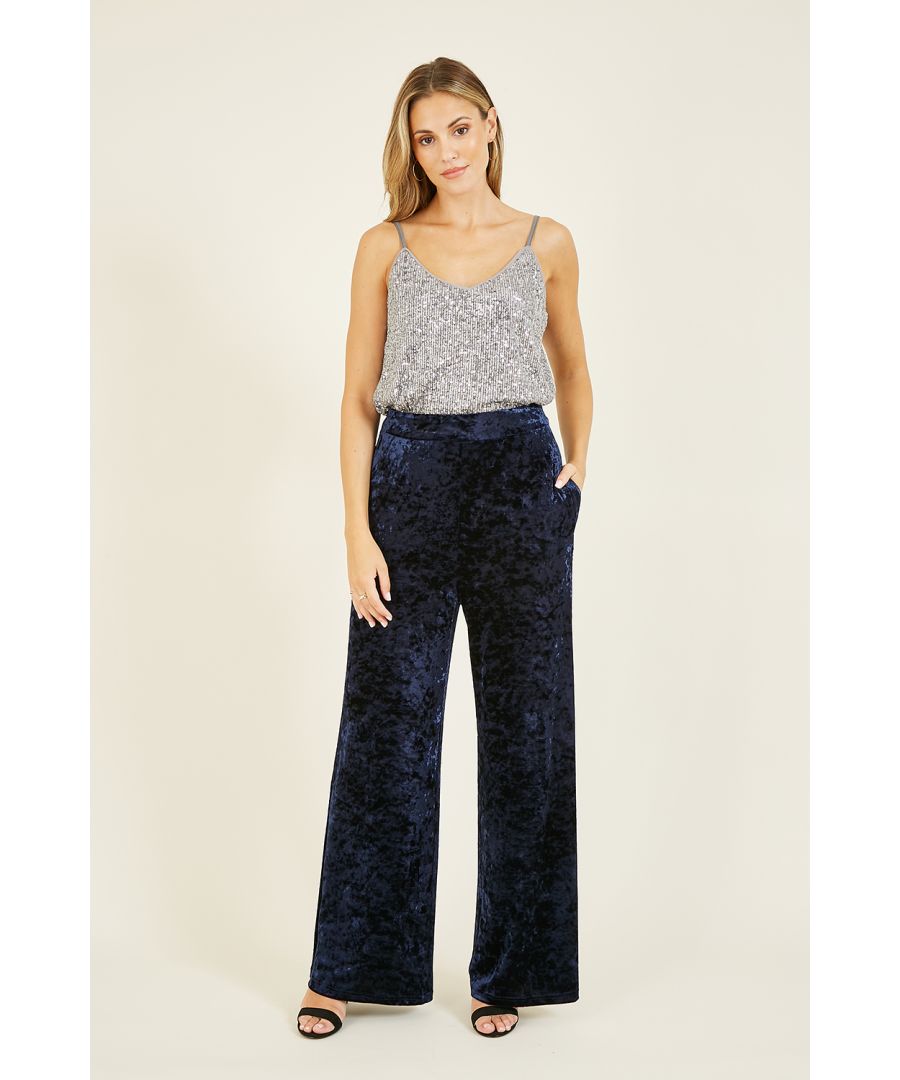 Look super sharp this season in these stunning Yumi Navy Velvet Palazzo Trousers. Crafted from soft crushed velvet, these flattering wide legged trousers are perfect for parties. Match with our Yumi Navy Velvet Wrap Jacket With Pockets and block heels for a killer look.