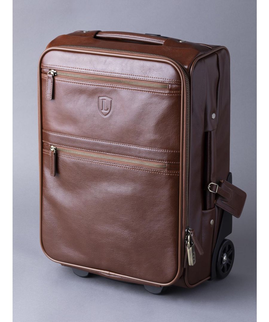 Take flight with the Fenton Trolley Leather Travel Case. A compact, practical and luxurious leather travel case with two sturdy wheels and a pull along handle that you can simply pack and go without care. Split into two sections, the base includes a double strap to keep your belongings compact, stored and safe. With zip compartments and velcro slip pockets, everything has its place. Practical and ideal in size to fit the majority of airlines cabin baggage allowance, you can store in the overhead locker or under your seat.  An item designed for the decades, not just the seasons.