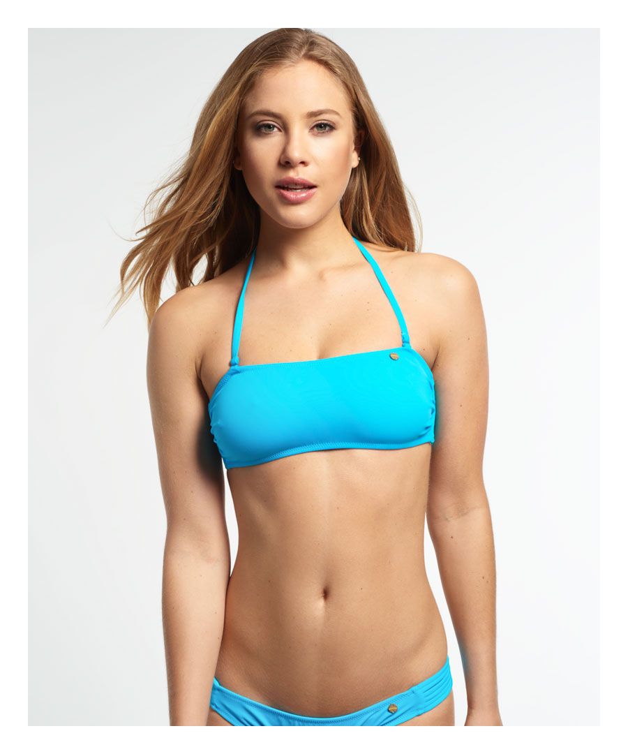 Superdry women's Santorini Bandeau Bikini Top. This bandeau style bikini top features two removable spaghetti straps, and a cut out design with multiple spaghetti straps along the back. The bikini top is finished with a small Superdry metal badge in the front.Model wears: Small Model height: 5’9” (175cm)