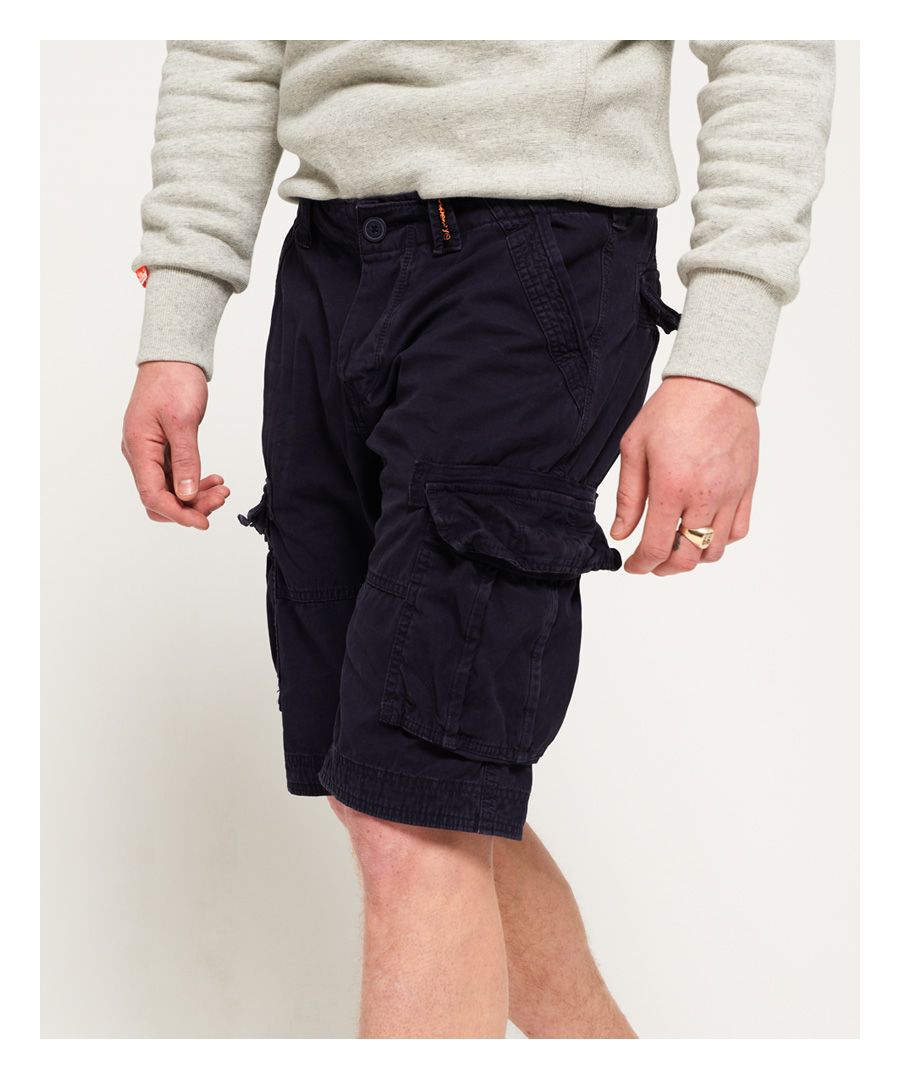 Superdry men's Core Cargo Lite Shorts. A pair of cargo shorts featuring a seven pocket design, button fly fastening, and belt loops. The shorts are finished with a Superdry logo patch on one of the belt loops and a logo tab above the back pocket.