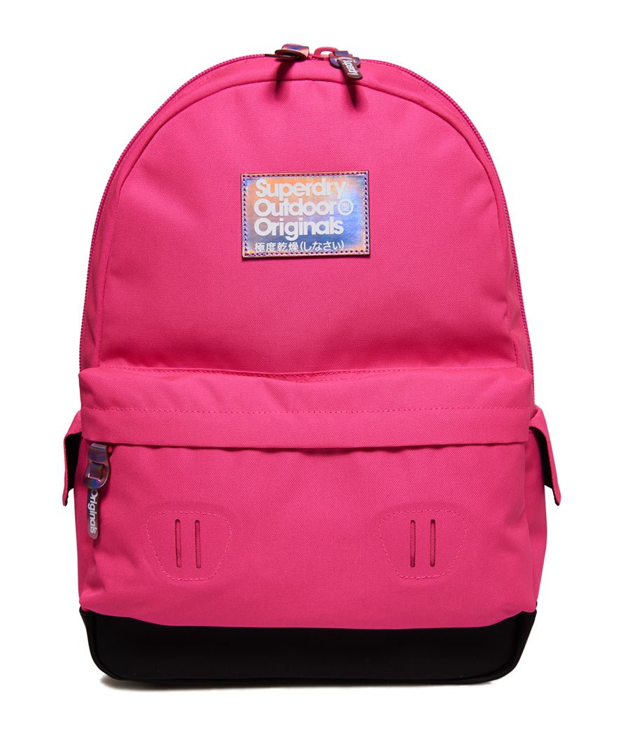 Superdry women’s Kaledo Montana rucksack. This simple yet staple rucksack features a top grab handle, padded back and straps and a large, zip fastened main compartment. The Kaledo Montana also features twin, popper fastened side pockets and a zipped outer compartment. The rucksack is finished with iridescent zip pulls and iridescent Superdry logo badges on the front and one strap. 21 litre approximate main compartment capacity.H 46cm x W 30.5cm x D 13.5cm