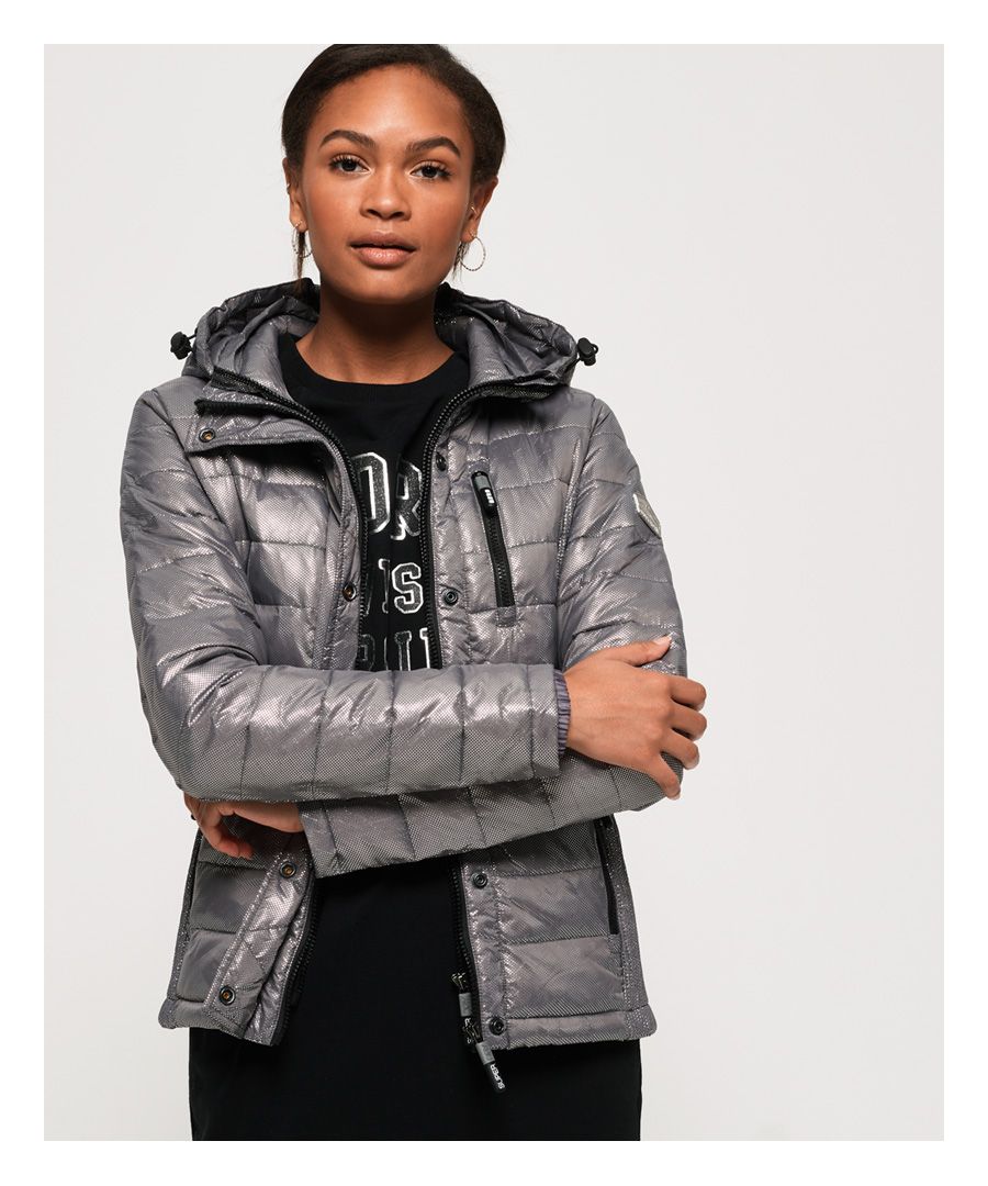 Superdry women’s Fuji Slim double zip hooded jacket. This classic quilted jacket features a popper front placket and a double layer zip fastening with two-way zips. The hood has a bungee cord adjuster and a stylish removable hood. The Fuji jacket also has elasticated side panels for added comfort and three external zipped pockets for practicality. The jacket is finished with a Superdry Mountain Goods badge on the left sleeve and elasticated cuffs.