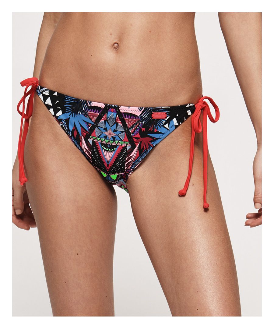 Superdry women's Aztec Craze tri bikini bottoms. Add some colour to your poolside ensemble this season with the Aztec Craze bikini bottoms. With tie side fastenings, these bikini bottoms are sure to become your new summer favourite.Matching top available.Please note due to hygiene reasons, we are unable to offer an exchange or refund on swimwear, unless they are sealed in their original packaging. This does not affect your statutory rights.