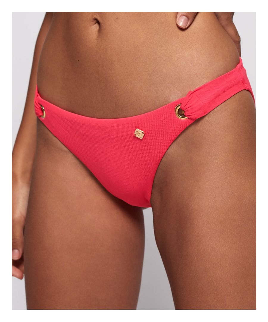 Superdry women’s Picot textured bikini bottoms. Brief shaped bikini bottoms in a delicate textured fabric, featuring eyelet detailing on the front and finished with a Superdry logo badge on the front.Matching bikini top available.Please note, due to hygiene reasons we are unable to offer an exchange or refund on swimwear unless the hygiene strip is still intact. This does not affect your statutory rights.