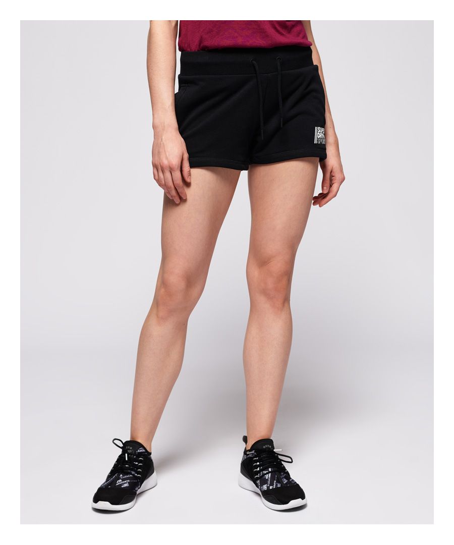Superdry women's Core sport shorts. Comfort that'll keep you looking and feeling fresh, these shorts are designed with four-way stretch technology for freedom of movement. Featuring a drawstring waistband, two pockets and textured Superdry logo on the front.