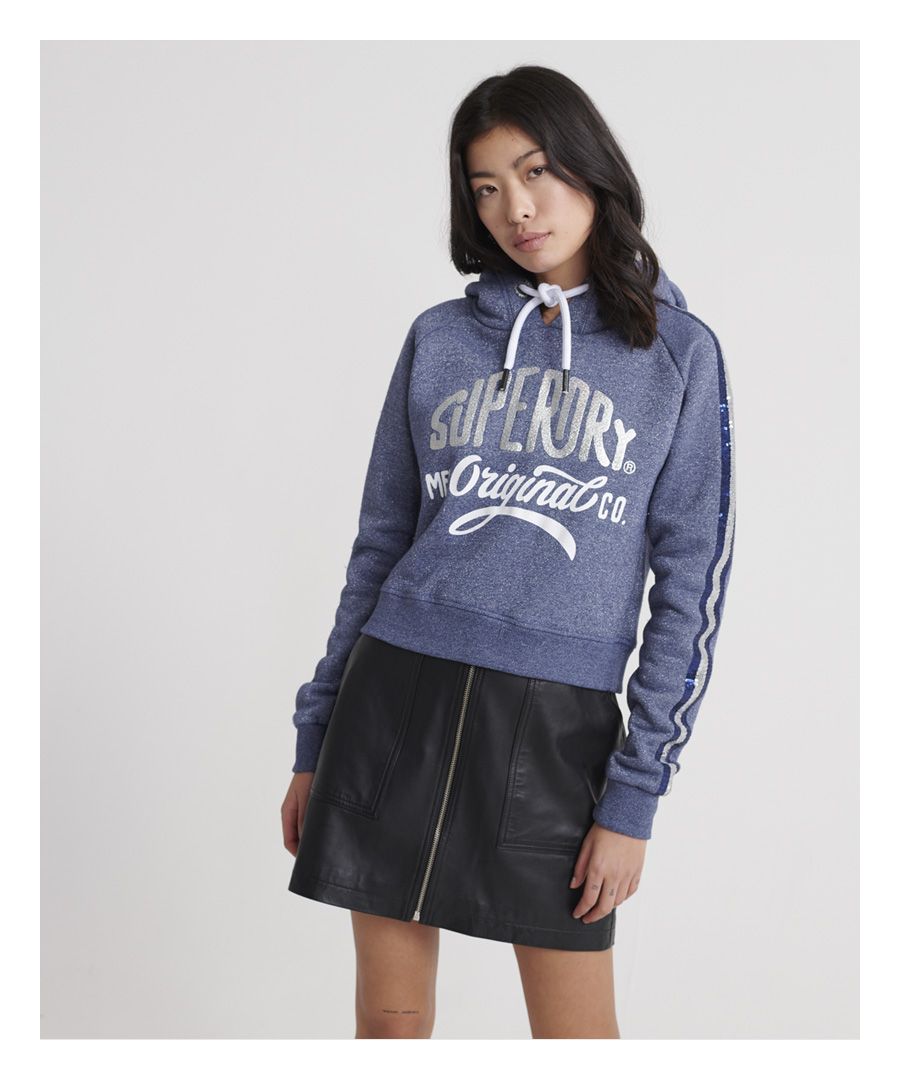 Superdry women's Classic Boutique original hoodie. Featuring an overhead cropped design, drawstring hood and ribbed hem and cuffs. Finished with sequin stripped detailing on both sleeves and a large textured Superdry logo to the chest.