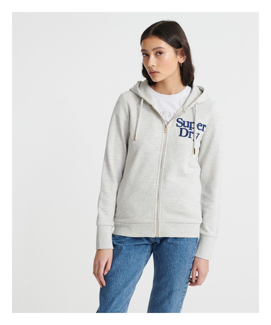 Superdry women's Embroidered Serif loopback zip hoodie. This hoodie features a zip fastening, drawstring hood, ribbed cuffs and hem and two front pockets. Complete with an embroidered Superdry logo on the chest and a Superdry logo tab on one side seam.Slim fit