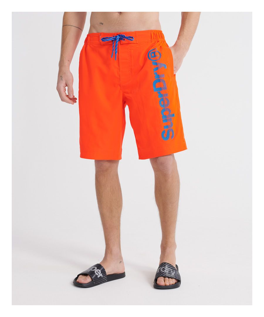 Superdry men's Classic boardshorts. These swim shorts feature a partly elasticated waistband, a single zip fastened pocket on the back, mesh lining and a drawstring and hook and loop fastening, Finished with a textured Superdry print down one leg, a rubber Superdry badge above the pocket, and a rubber Superdry logo tab on the waistband.Please note due to hygiene reasons, we are unable to offer an exchange or refund on underwear, unless they are sealed in their original packaging. This does not affect your statutory rights.
