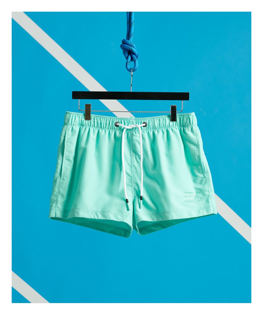 Superdry men's Sorrento swim shorts. These swim shorts feature a drawstring waistband, two front hook and loop pockets and a hanging loop on the back. Complete with a textured Superdry logo on the hemline and full mesh lining.Please note due to hygiene reasons, we are unable to offer an exchange or refund on swimwear, unless they are sealed in their original packaging. This does not affect your statutory rights.
