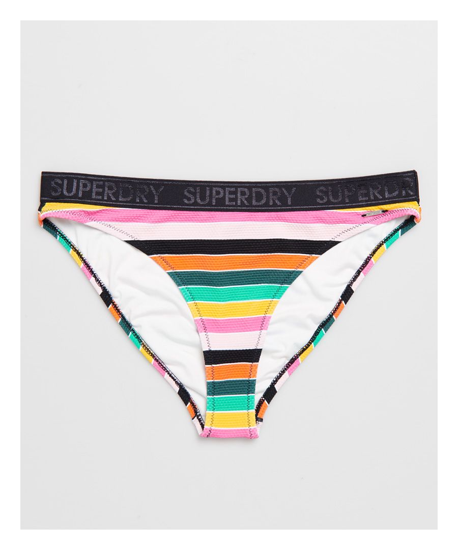 Superdry women's Stripe bikini bottoms. These bikini bottoms feature a horizontal stripe design, Superdry branded elasticated waistband and metal Superdry logo bade on the waist. Pair with the corresponding bikini top to complete the look.Please note due to hygiene reasons, we are unable to offer an exchange or refund on swimwear, unless they are sealed in their original packaging. This does not affect your statutory rights.