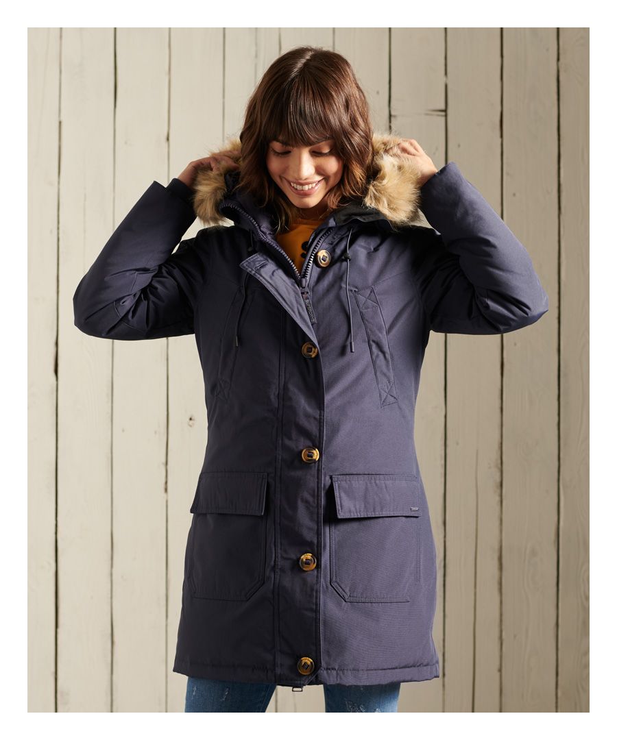 Superdry women’s Rookie down parka jacket. The Rookie down parka jacket is filled with an 80/20 premium duck down filling and has a medium fill power rating, providing fantastic insulation for when the temperature drops. The jacket features a bungee cord adjustable hood with detachable faux fur trim, a zip and button fastening and four front pockets. This jacket also features a bungee cord adjustable waist for your perfect fit. The Rookie Down Parka is finished with a Superdry logo badge on one sleeve.Superdry is certified by the Responsible Down Standard to confirm that our down filled products are sourced to ensure animal welfare.