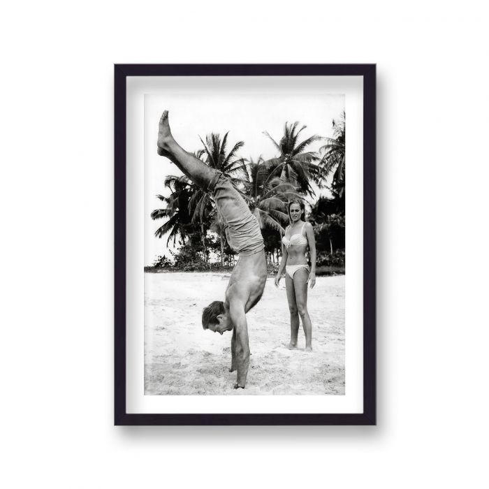 Sean Connery as James Bond Does Handstand Ursula Andress as Honey Rider Relaxing On Set Dr No
